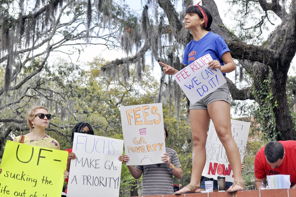 Diana Moreno, a 27-year-old Latin American studies masters candidate and chief coordinator of Graduate Assistants United, speaks at the GAU "Spring Broke" rally in Turlington Plaza on Friday. "My problems are shared with my colleagues and we have to work together to solve them," she said on reducing graduate assistant fees.