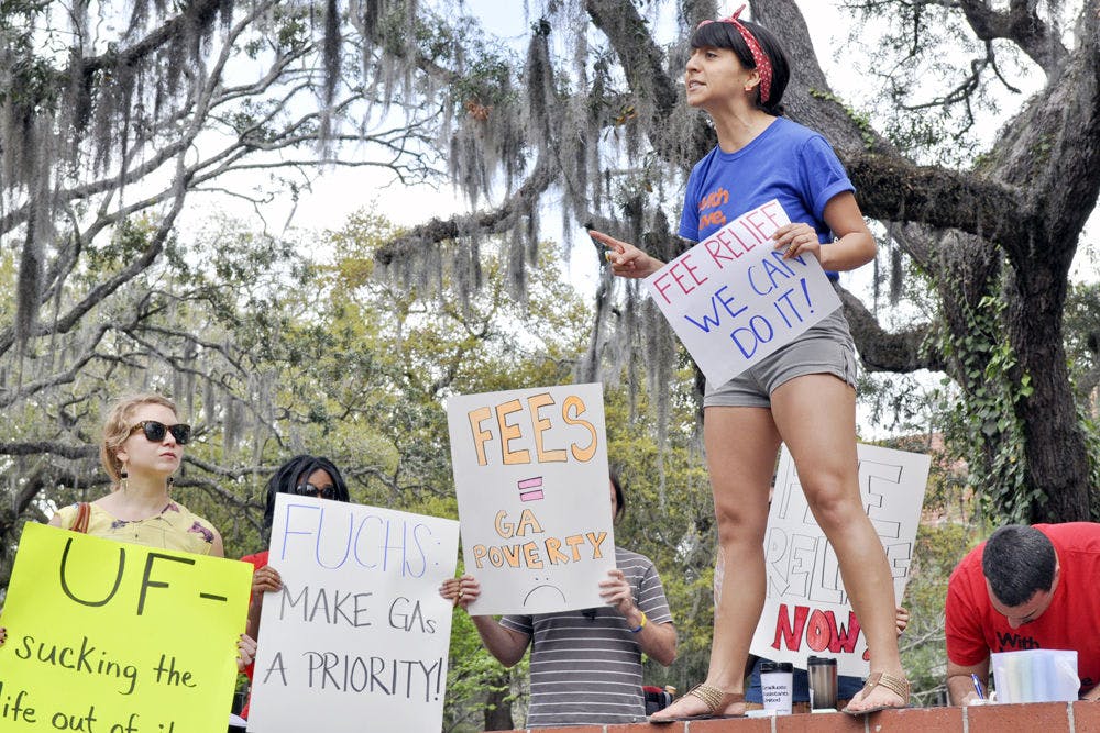 <p>Diana Moreno, a 27-year-old Latin American studies masters candidate and chief coordinator of Graduate Assistants United, speaks at the GAU "Spring Broke" rally in Turlington Plaza on Friday. "My problems are shared with my colleagues and we have to work together to solve them," she said on reducing graduate assistant fees.</p>