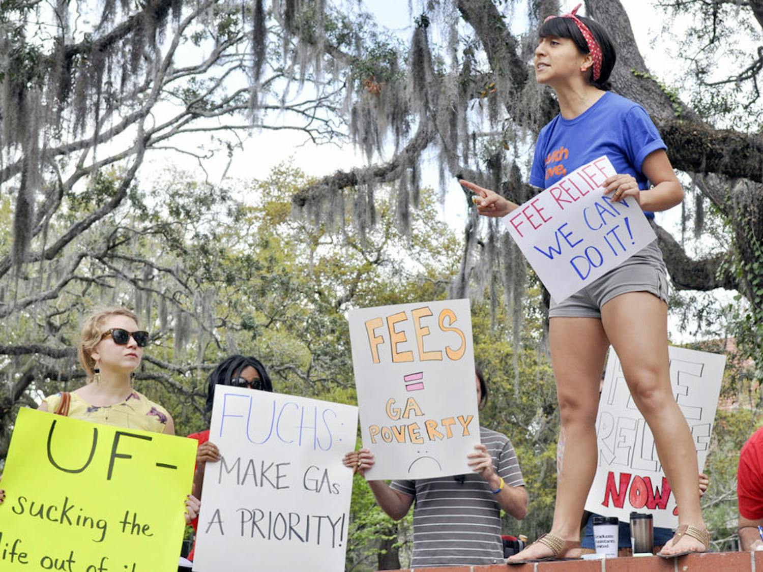 Diana Moreno, a 27-year-old Latin American studies masters candidate and chief coordinator of Graduate Assistants United, speaks at the GAU "Spring Broke" rally in Turlington Plaza on Friday. "My problems are shared with my colleagues and we have to work together to solve them," she said on reducing graduate assistant fees.