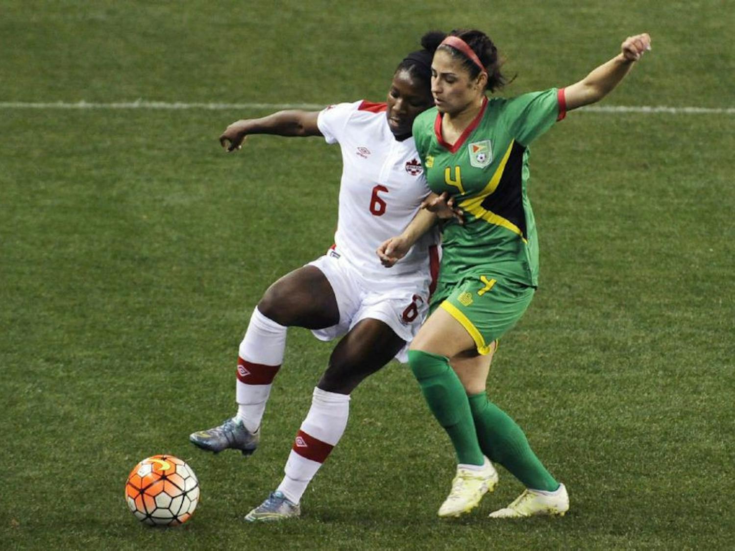 Canada's Deanne Rose, left, fends off Guyana's Kayle De Souza during Olympic qualifying action Thursday. Rose scored two goals in a breakout performance. (PAT SULLIVAN / THE ASSOCIATED PRESS)