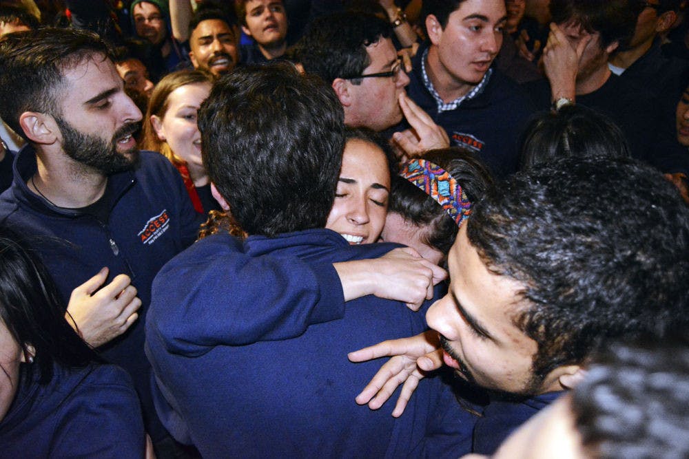 <p>President-elect Joselin Padron-Rasines (center) hugs Matthew Hoeck, Access Party president, after the announcement that Access won the Student Government presidential ticket. Nicholas Carre (right), SG treasurer-elect, joined in their celebration.</p>