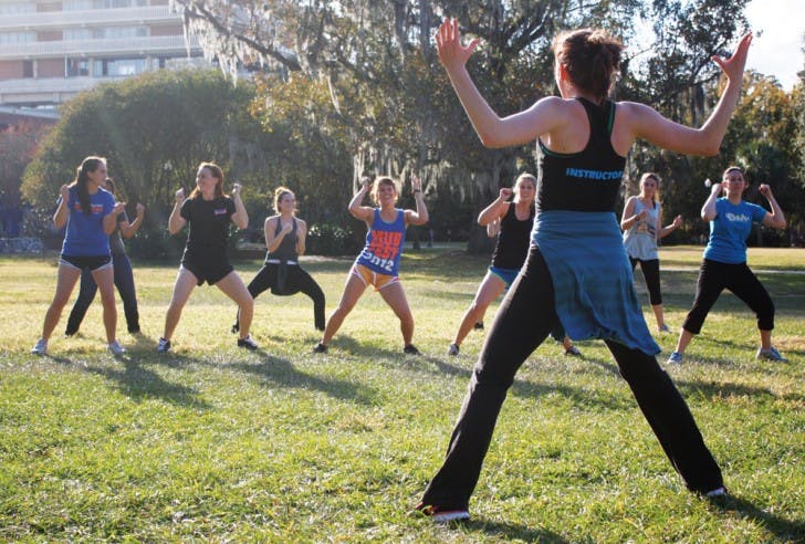 Jenny Squires, a dance junior who plans to pursue physical therapy, teaches a Zumba class Tuesday afternoon on the North Lawn. The class was a Dance Marathon fundraiser. Read the story on page 3.