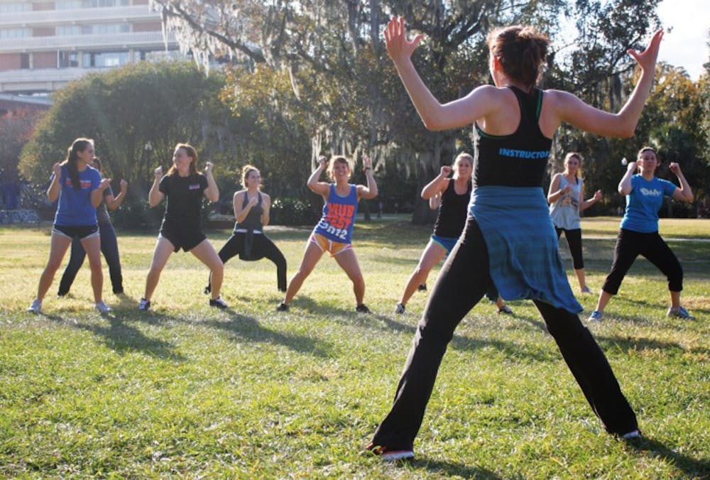 <p>Jenny Squires, a dance junior who plans to pursue physical therapy, teaches a Zumba class Tuesday afternoon on the North Lawn. The class was a Dance Marathon fundraiser. Read the story on page 3.</p>