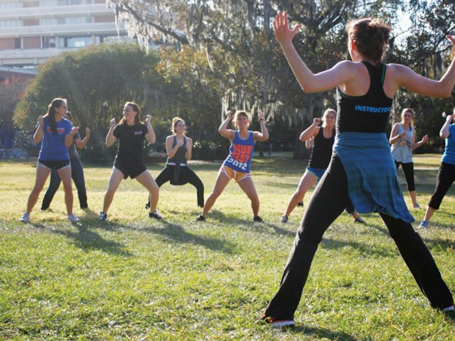 Jenny Squires, a dance junior who plans to pursue physical therapy, teaches a Zumba class Tuesday afternoon on the North Lawn. The class was a Dance Marathon fundraiser. Read the story on page 3.