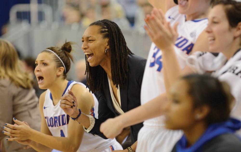 <p>Redshirt freshman guard Carlie Needles (left), assistant coach Murriel Page (center) and the Gators cheer from the bench during Florida’s 77-72 win against LSU on Sunday in the O’Connell Center.</p>