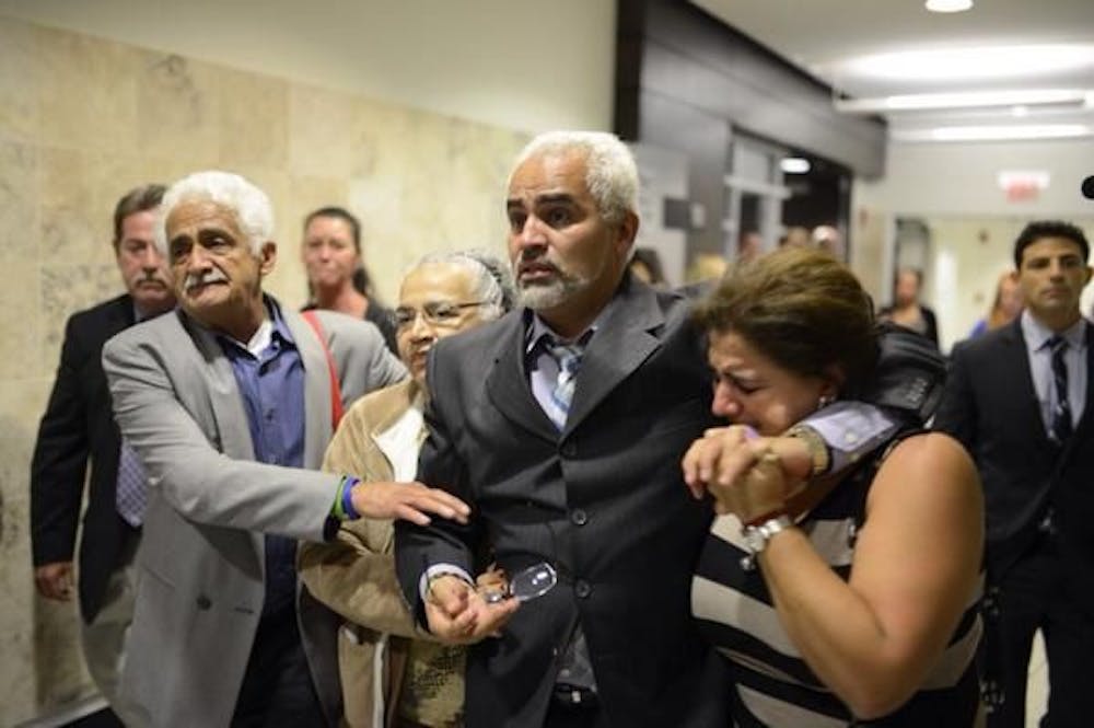 <p><span>Carlos Aguilar is surrounded by family as he leaves the courtroom.</span></p>