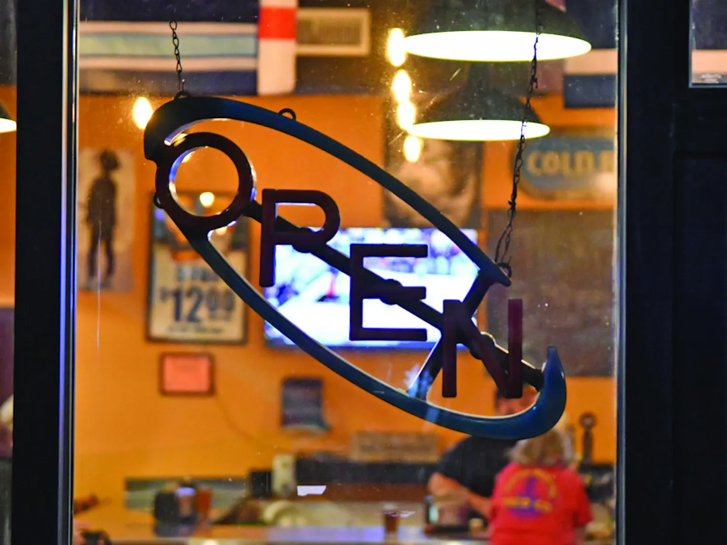 The “open” light is turned off as employees reminisce in the background about their time at Burrito Brothers Taco Co. Burrito Brothers shut down for good Saturday evening after running out of food around 6:30 p.m.
