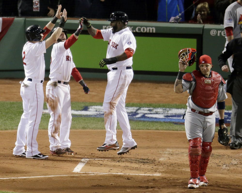 <p>St. Louis Cardinals catcher Yadier Molina (right) walks away as Boston Red Sox designated hitter David Ortiz (center) celebrates with Jacoby Ellsbury (left) and Dustin Pedroia after scoring during the first inning of Game 1 of the World Series on Wednesday in Boston.</p>