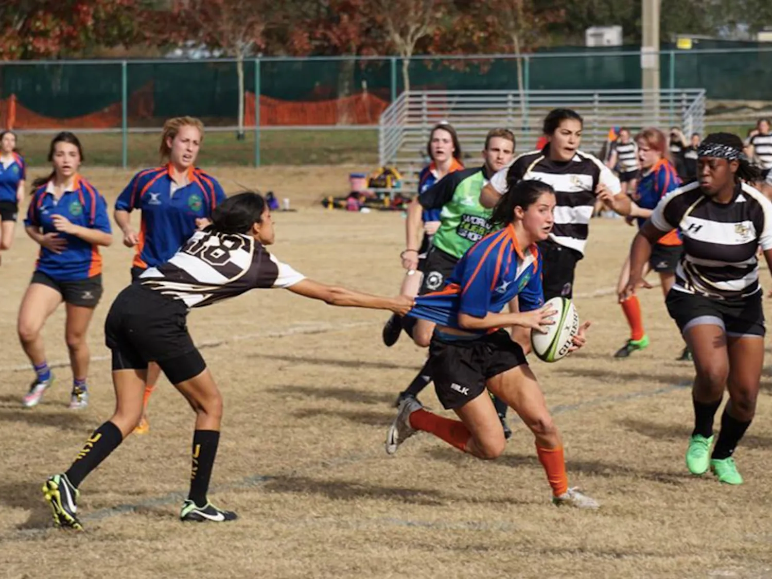 Abby Solaun, a UF Women’s Rugby Club player, tries to dodge a University of Central Florida player during a match in February. Moriah Saunders, one of the team’s captains, said old team uniforms are becoming an issue during games.