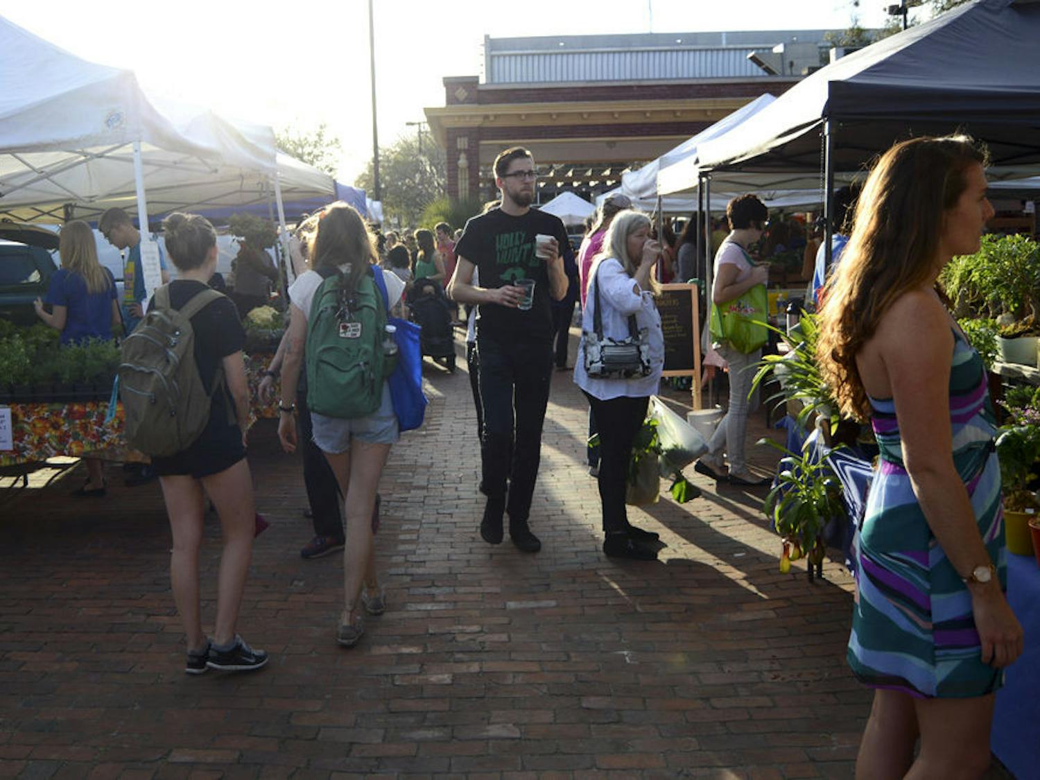 Gainesville residents browse vendors’ wares on Wednesday afternoon at the first Union Street Farmers Market after the Bo Diddley Plaza renovation. Previously, the farmers market was being held on Lot 10 in downtown Gainesville.