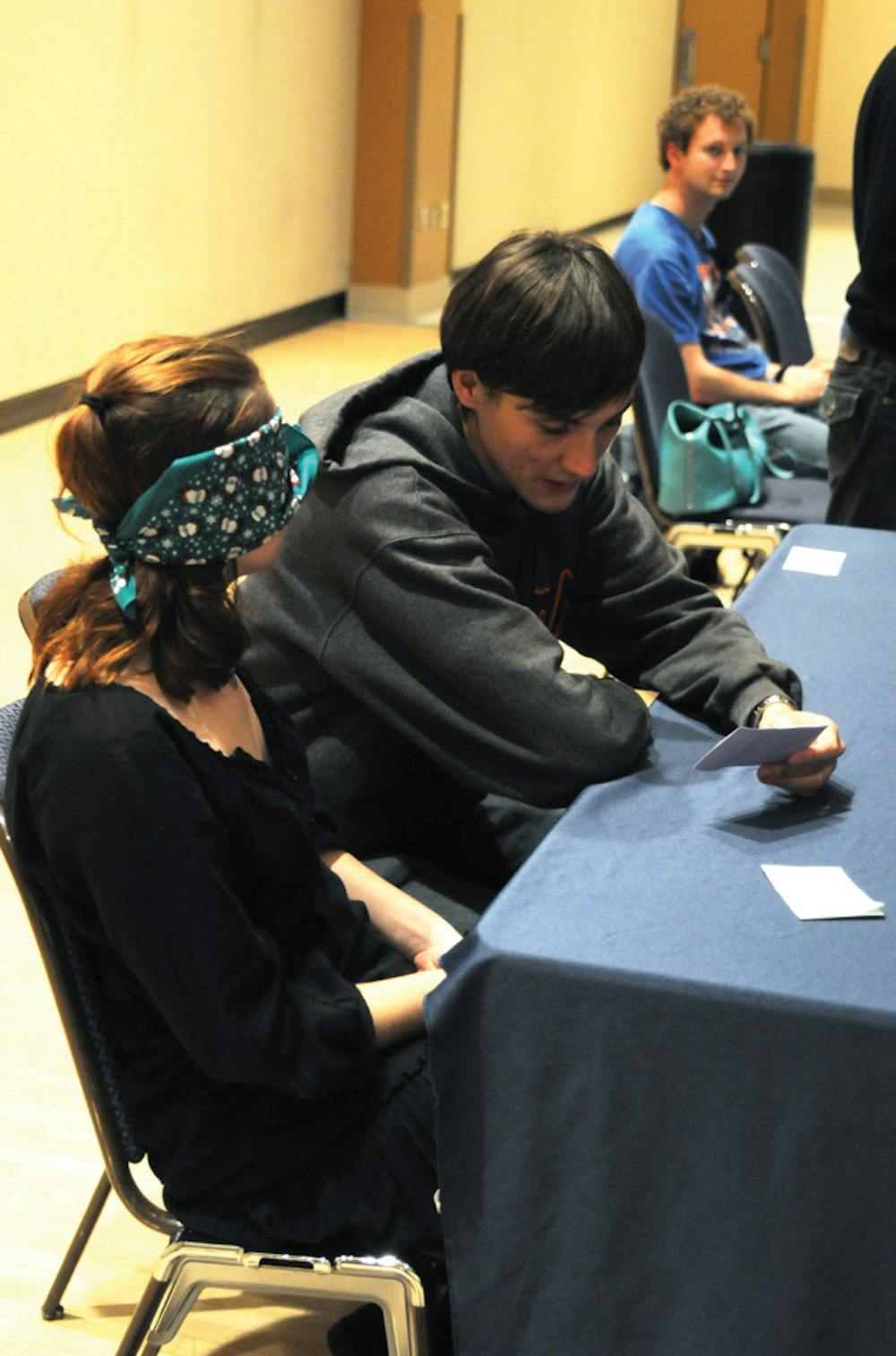 <p>UF materials science and engineering junior Matt Wener, 21, wears earplugs and assists UF English senior Constance Hackler, 20, who wears a blindfold as part of the Dining with Disabilities event in the Reitz Union Rion Ballroom on Monday evening. Participants were challenged with an assigned disability to gain a better understanding of others’ lifestyles.</p>