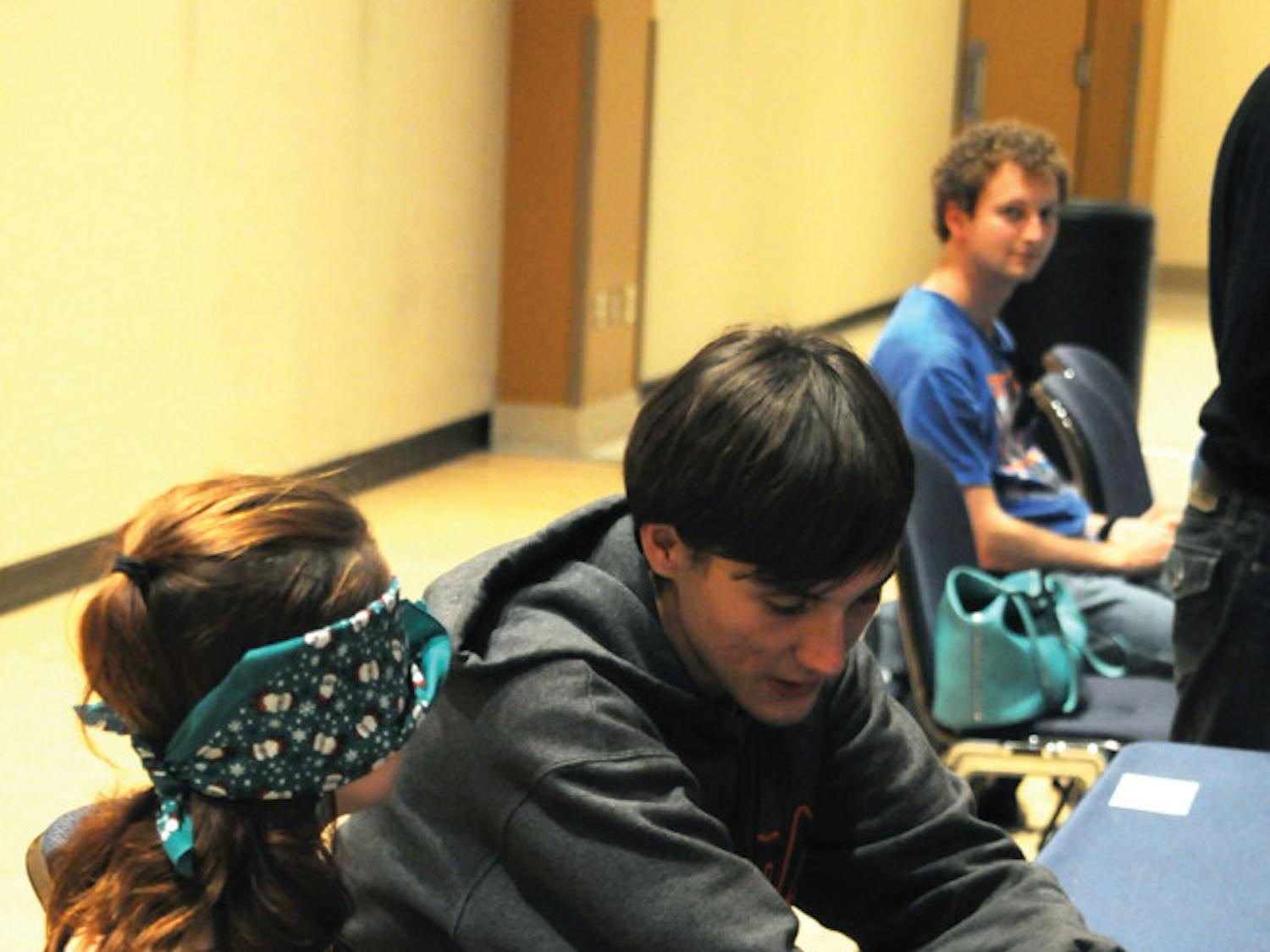 UF materials science and engineering junior Matt Wener, 21, wears earplugs and assists UF English senior Constance Hackler, 20, who wears a blindfold as part of the Dining with Disabilities event in the Reitz Union Rion Ballroom on Monday evening. Participants were challenged with an assigned disability to gain a better understanding of others’ lifestyles.
