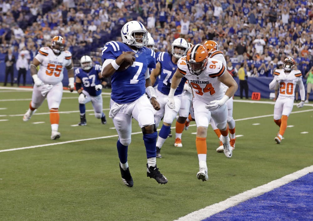 Indianapolis Colts quarterback Jacoby Brissett (7) runs in for a touchdown in front of Cleveland Browns defensive end Carl Nassib (94) during the first half of an NFL football game in Indianapolis, Sunday, Sept. 24, 2017. (AP Photo/Darron Cummings)