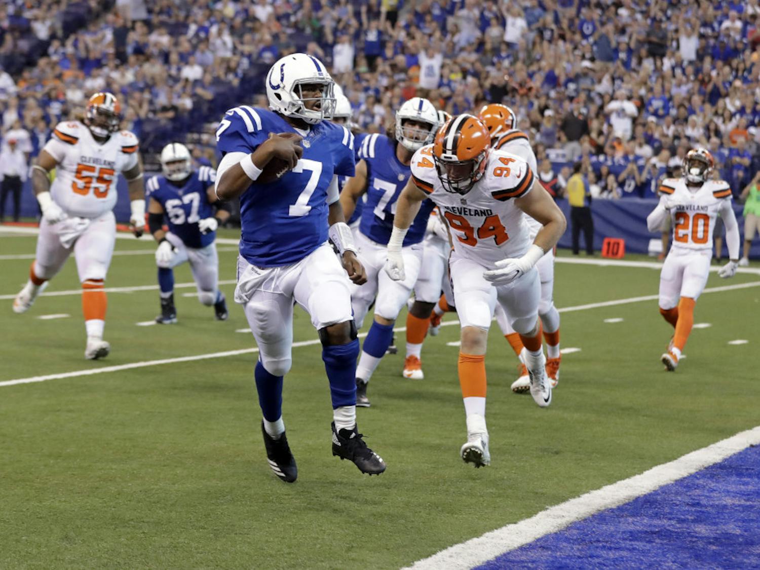Indianapolis Colts quarterback Jacoby Brissett (7) runs in for a touchdown in front of Cleveland Browns defensive end Carl Nassib (94) during the first half of an NFL football game in Indianapolis, Sunday, Sept. 24, 2017. (AP Photo/Darron Cummings)