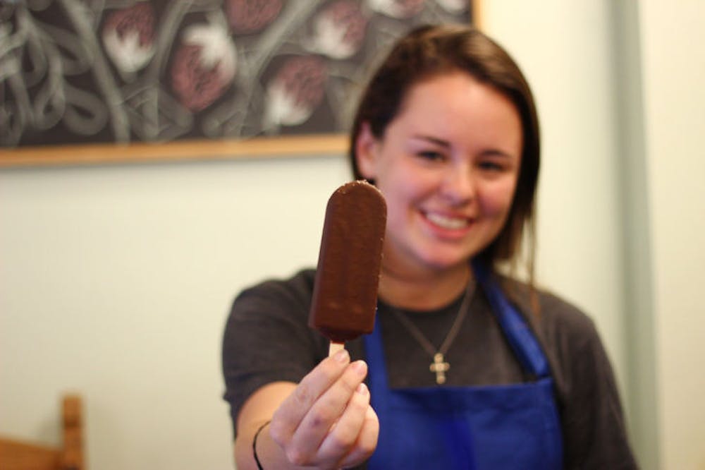 <p class="p1"><span class="s1">Nicole Giaquinto, a 20-year-old UF public relations sophomore, displays a chocolate-covered ice pop at The Hyppo Gourmet Ice Pops on Monday evening. The Hyppo opened its doors for the first time this weekend.&nbsp;</span></p>