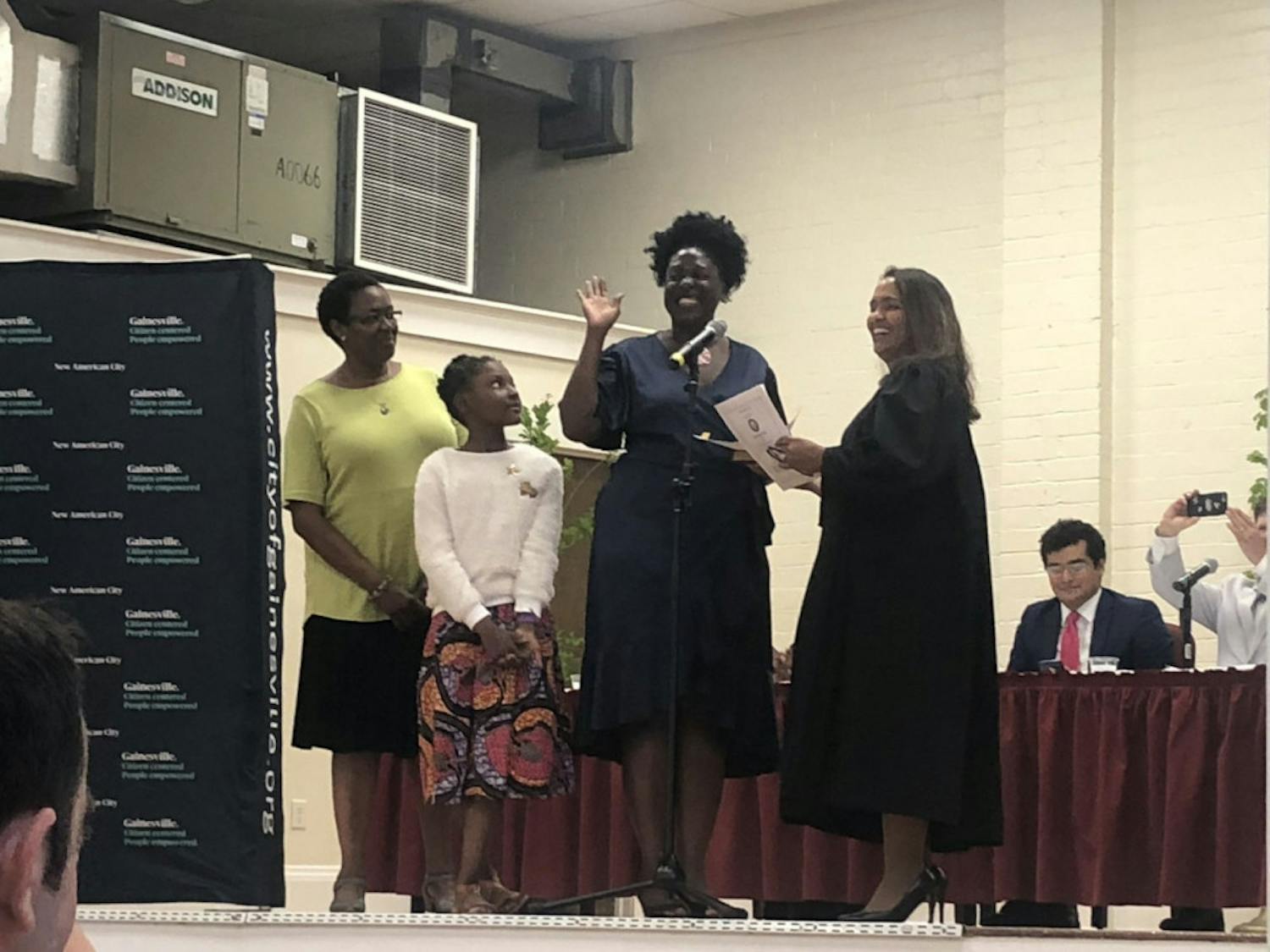 Gail Johnson (center right) is sworn into office alongside her daughter&nbsp;Zora (center left).
