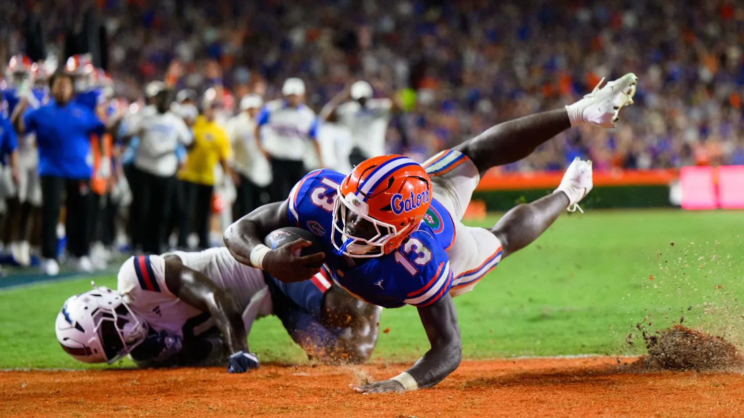 Florida running back Jadan Baugh (13) scores a touchdown during the first half of an NCAA college football game against FAU, Saturday, Sept. 5, 2026, in Gainesville, Fla.