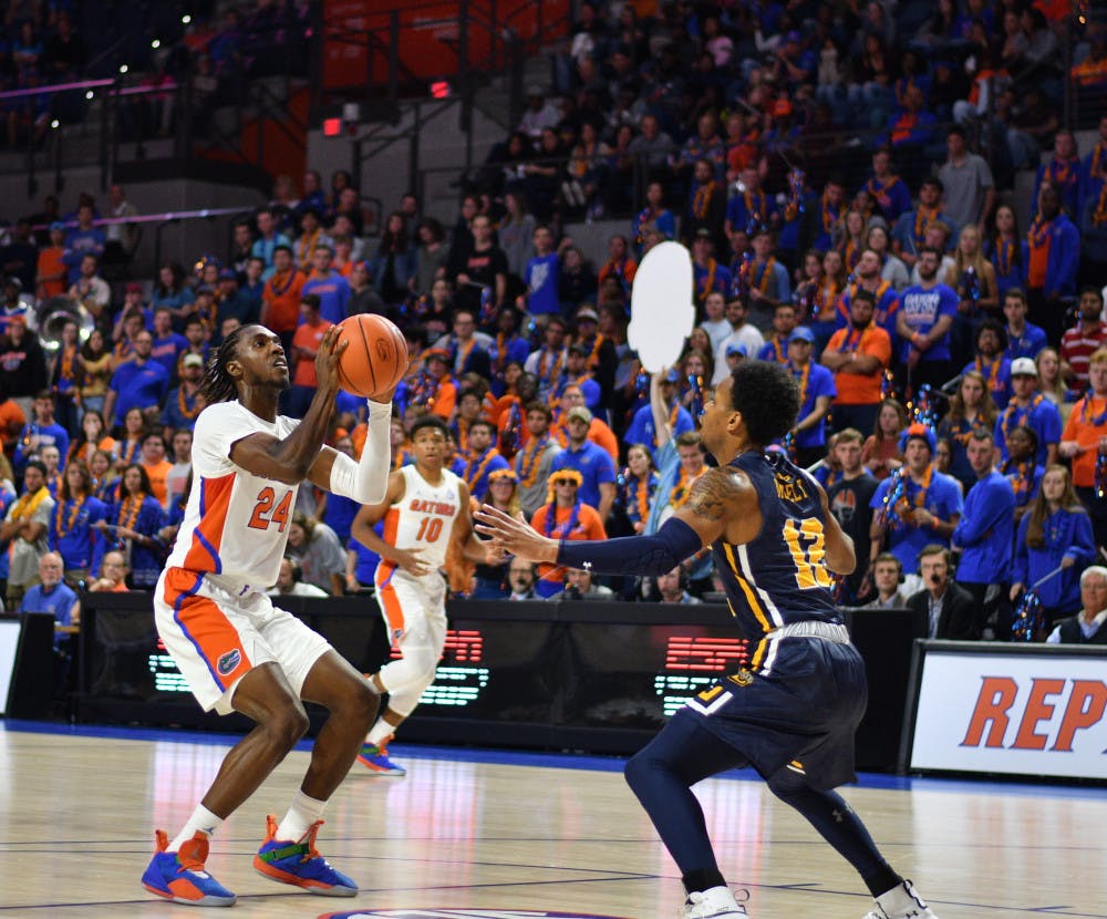 <p>Guard Deaundrae Ballard (24) leads the Gators with 10.2 points per game through their first six games. </p>