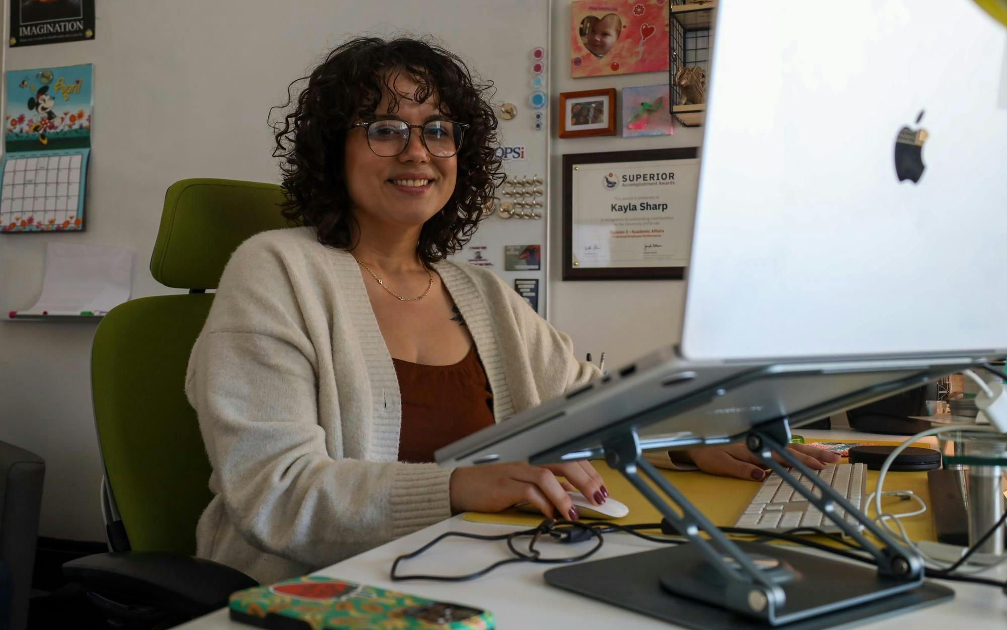 Assistant Director of Operations for E-Learning, Technology and Communications at the University of Florida College of Education Kayla Sharp poses at her desk on Thursday, April 2, 2026 in Gainesville, Fla.