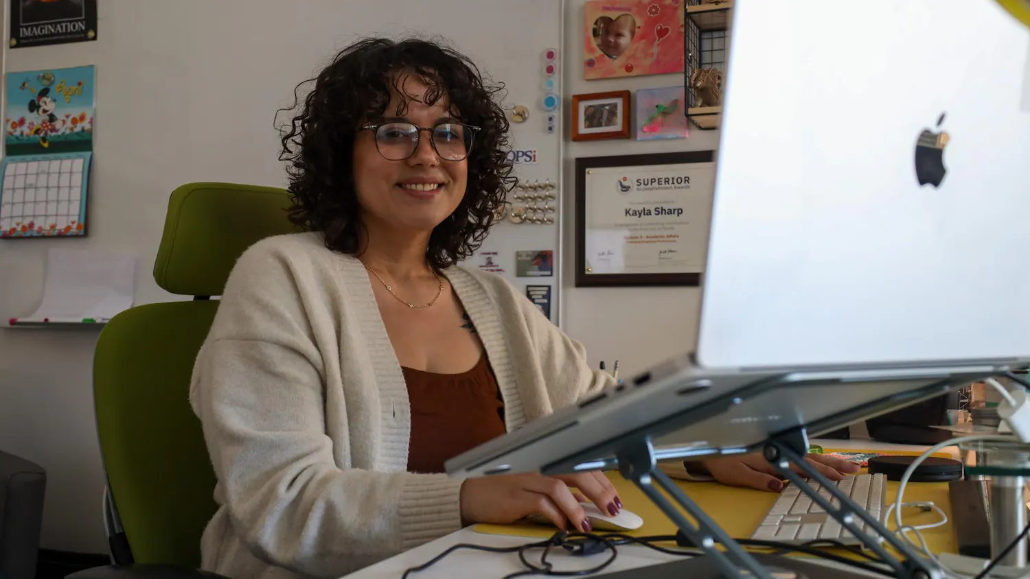 Assistant Director of Operations for E-Learning, Technology and Communications at the University of Florida College of Education Kayla Sharp poses at her desk on Thursday, April 2, 2026 in Gainesville, Fla.