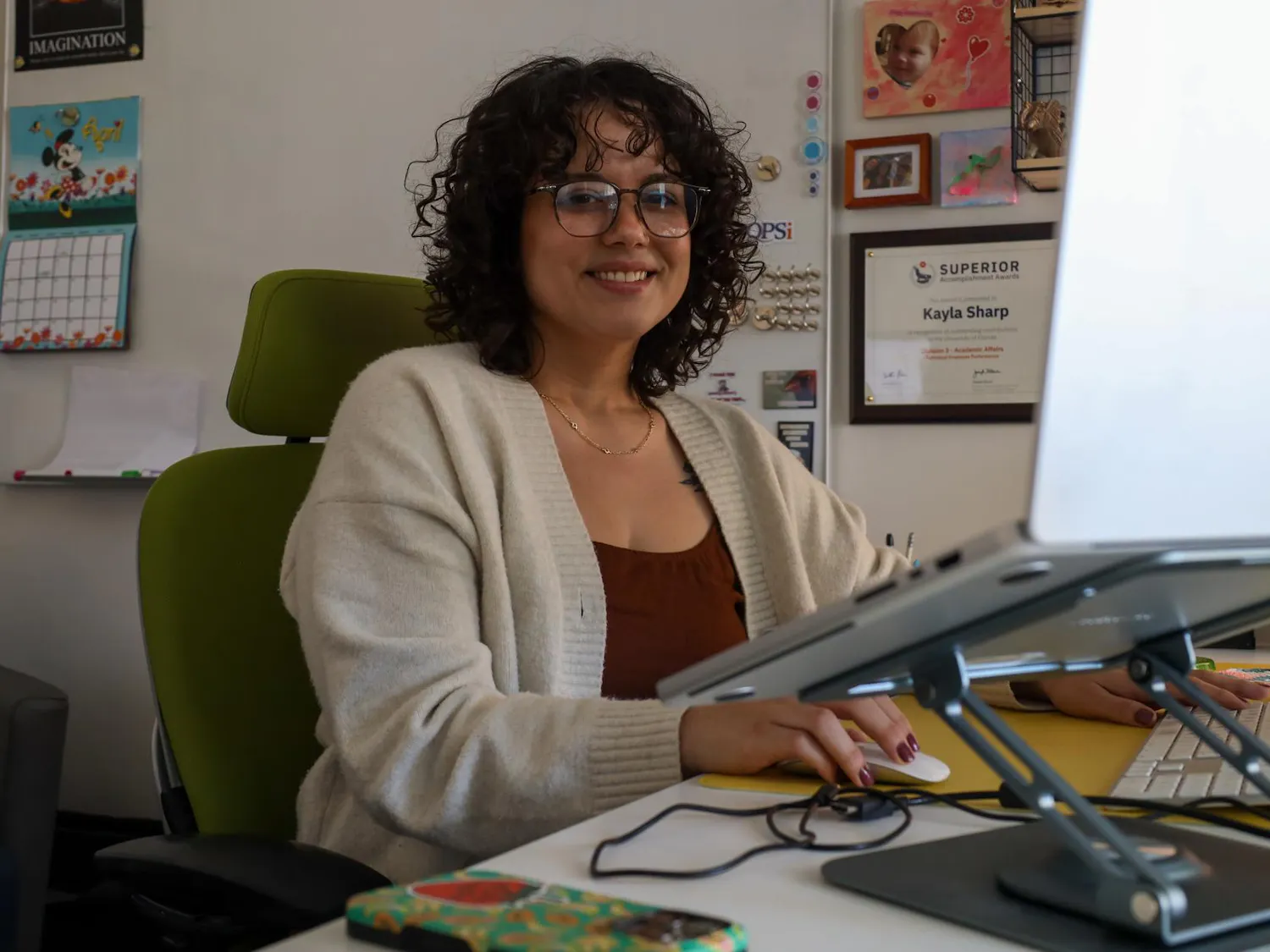 Assistant Director of Operations for E-Learning, Technology and Communications at the University of Florida College of Education Kayla Sharp poses at her desk on Thursday, April 2, 2026 in Gainesville, Fla.