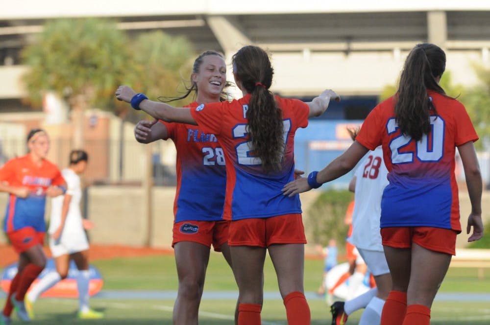 <p>UF midfielders Meggie Dougherty Howard (28) and Mayra Pelayo celebrate after Pelayo scores the first goal in Florida's 5-2 win against Iowa State on Aug. 19, 2016, at James G. Pressly Stadium.</p>