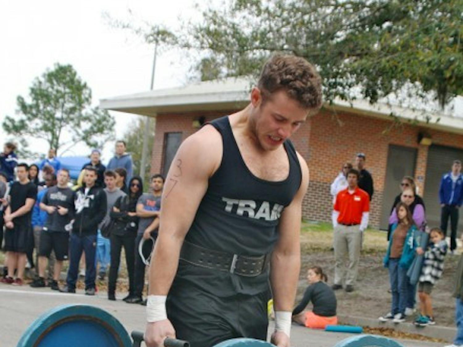 Economics junior Matthew Schaler participates in the Strong Gator competition at Maguire Field on Saturday.