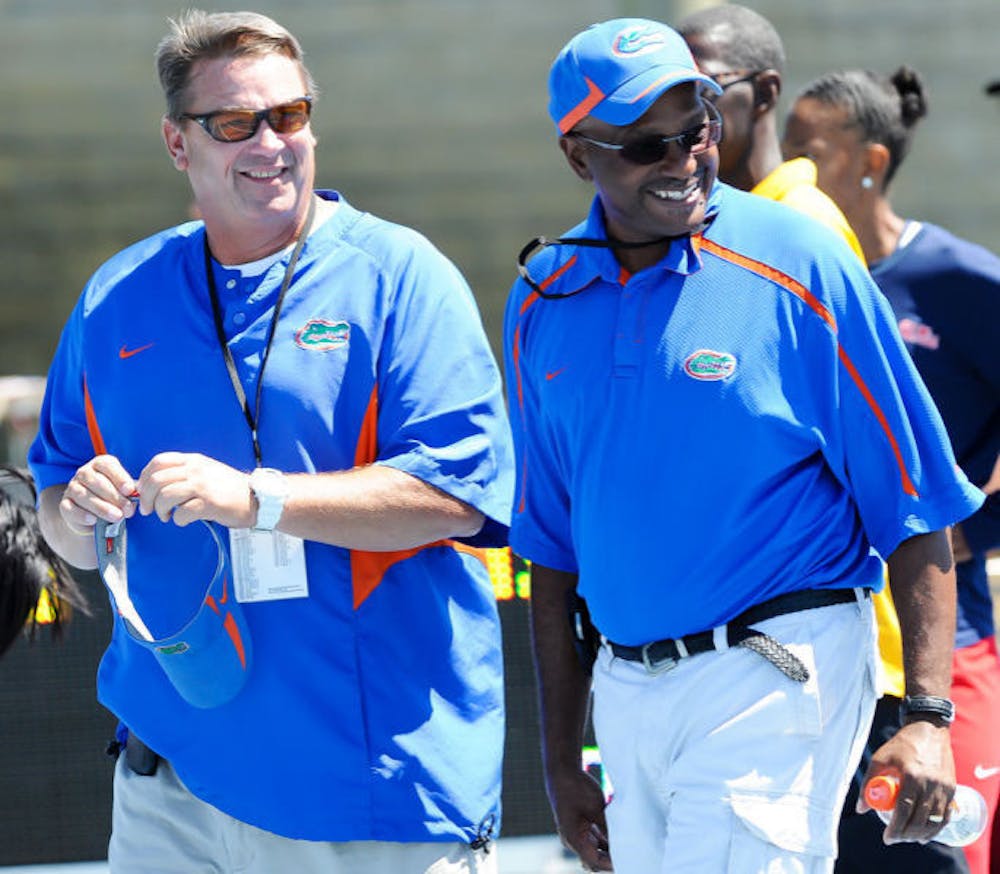 <p align="justify">Throwers coach Steve Lemke (left) and coach Mike Holloway walk across the field at Percy Beard Track at Pressly Stadium during the 2012 Florida Relays. Seventeen Gators qualified Sunday for the NCAA Outdoor Championships, which are set to begin June 5.&nbsp;</p>