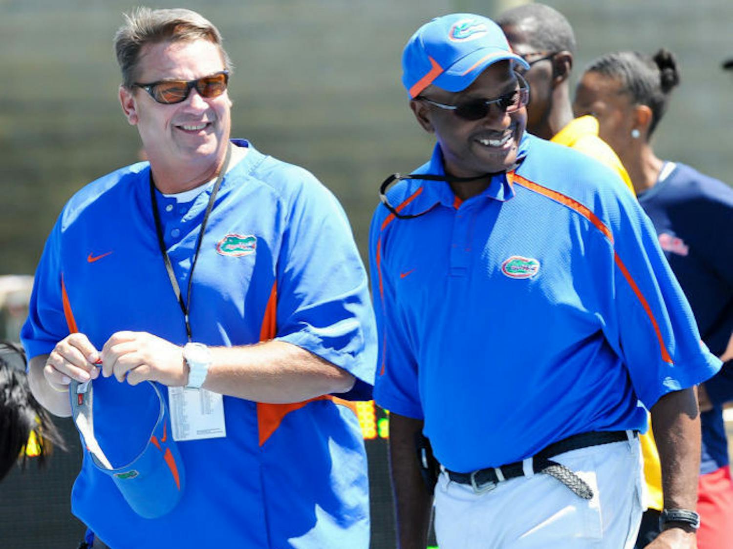 Throwers coach Steve Lemke (left) and coach Mike Holloway walk across the field at Percy Beard Track at Pressly Stadium during the 2012 Florida Relays. Seventeen Gators qualified Sunday for the NCAA Outdoor Championships, which are set to begin June 5. 