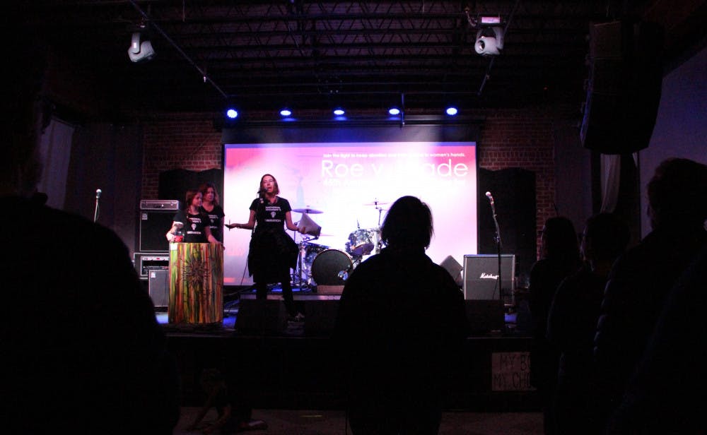 <p>Amy Coenen and her daughter Ella share the stage with another member of the National Women's Liberation organization right before announcing the first winners to the raffle inside The Wooly on Saturday night. The anniversary show was put together to celebrate the 45th anniversary of the Roe v. Wade decision.</p>