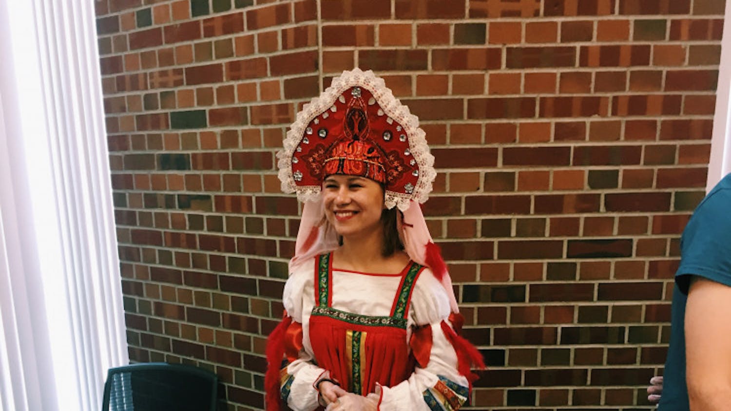 UF Russian Culture Club president Daria Bulatnikova serves food at their annual fall festival, which changes themes each year.