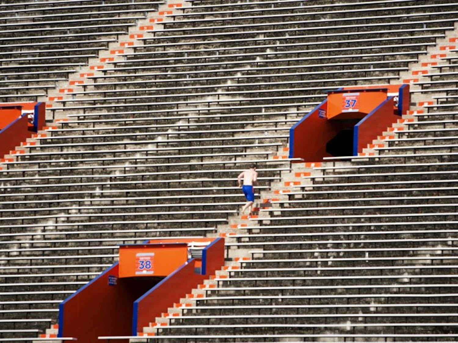 A man run stadiums in order to stay fit in Ben Hill Griffin Stadium on Aug. 10.