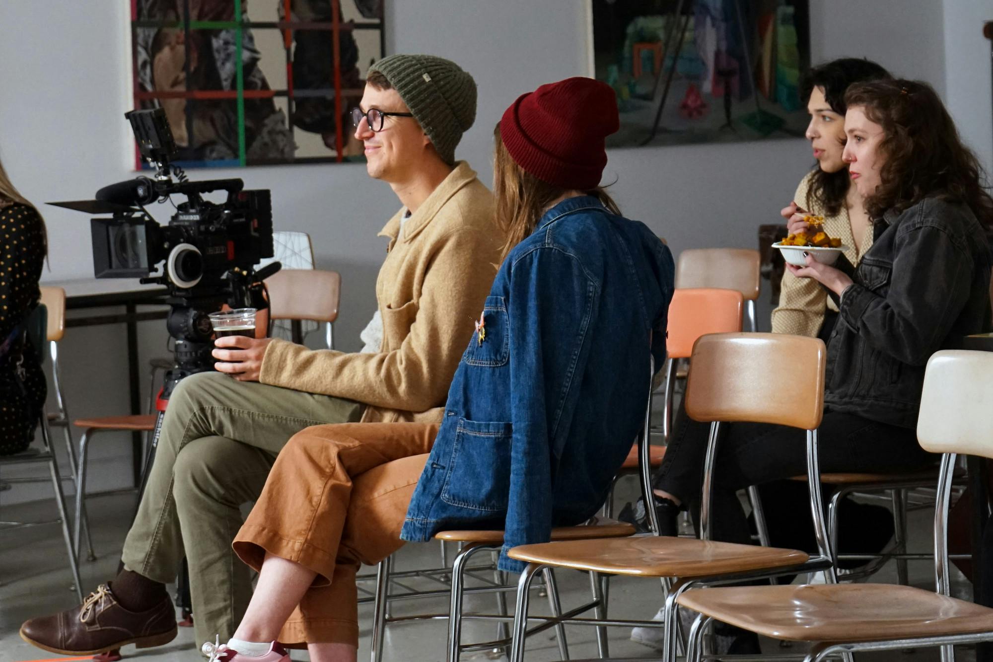 Attendees of the launch party watch the members of the podcast Girlish get mic’ed up for the live panel recording Thursday, Jan. 26, 2023.