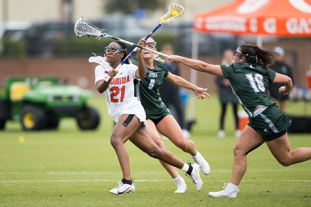 Florida Gators attack Clark Hamilton (21) runs with the ball in a lacrosse game against Loyola Maryland in Gainesville, Fla., on Saturday, March 8, 2025.