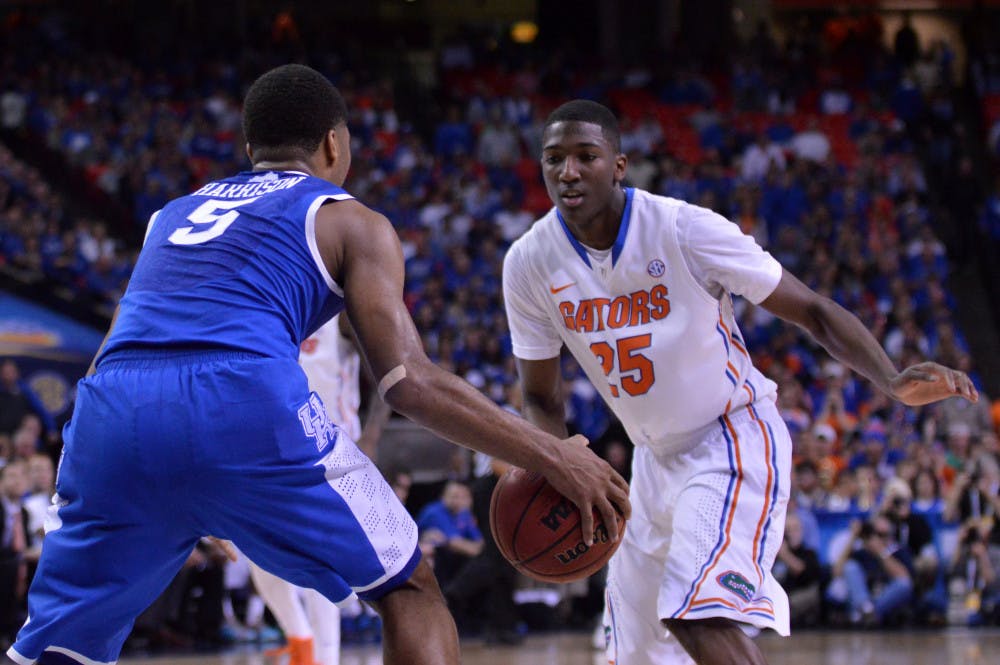 DeVon Walker defends Kentucky’s Andrew Harrison during the Gators’ 61-60 win against the Wildcats on March 16 in the Georgia Dome in Atlanta. Walker will likely seek a medical redshirt for the 2014-15 season after tearing his ACL.