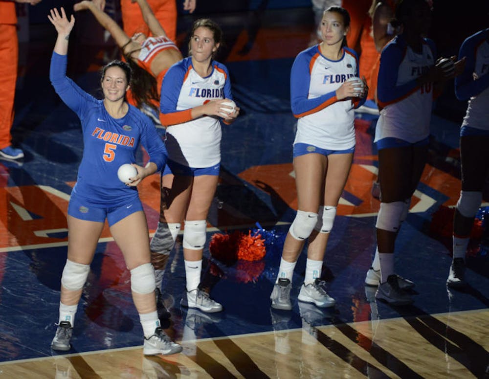 <p>Junior libero Taylor Unroe waves to the crowd during introductions prior to Florida’s four-set victory against Western Michigan on Sept. 14 in the O’Connell Center.</p>