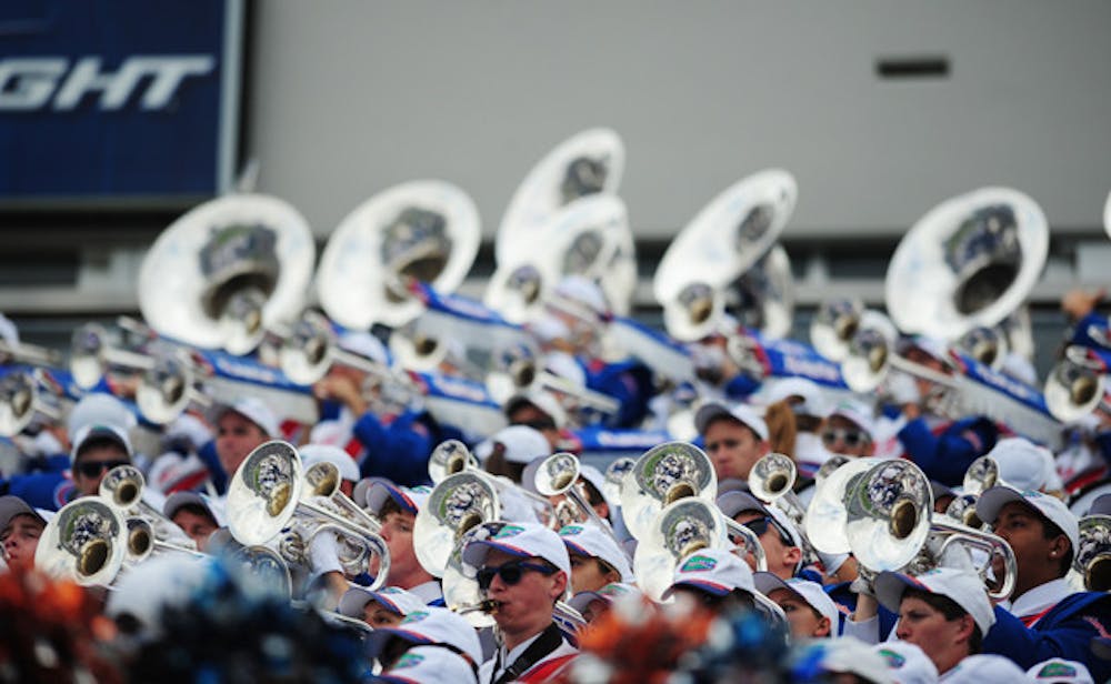 <p>The UF Fightin' Gator Marching Band performs in the stands at the football game against Georgia in Jacksonville on Saturday.</p>