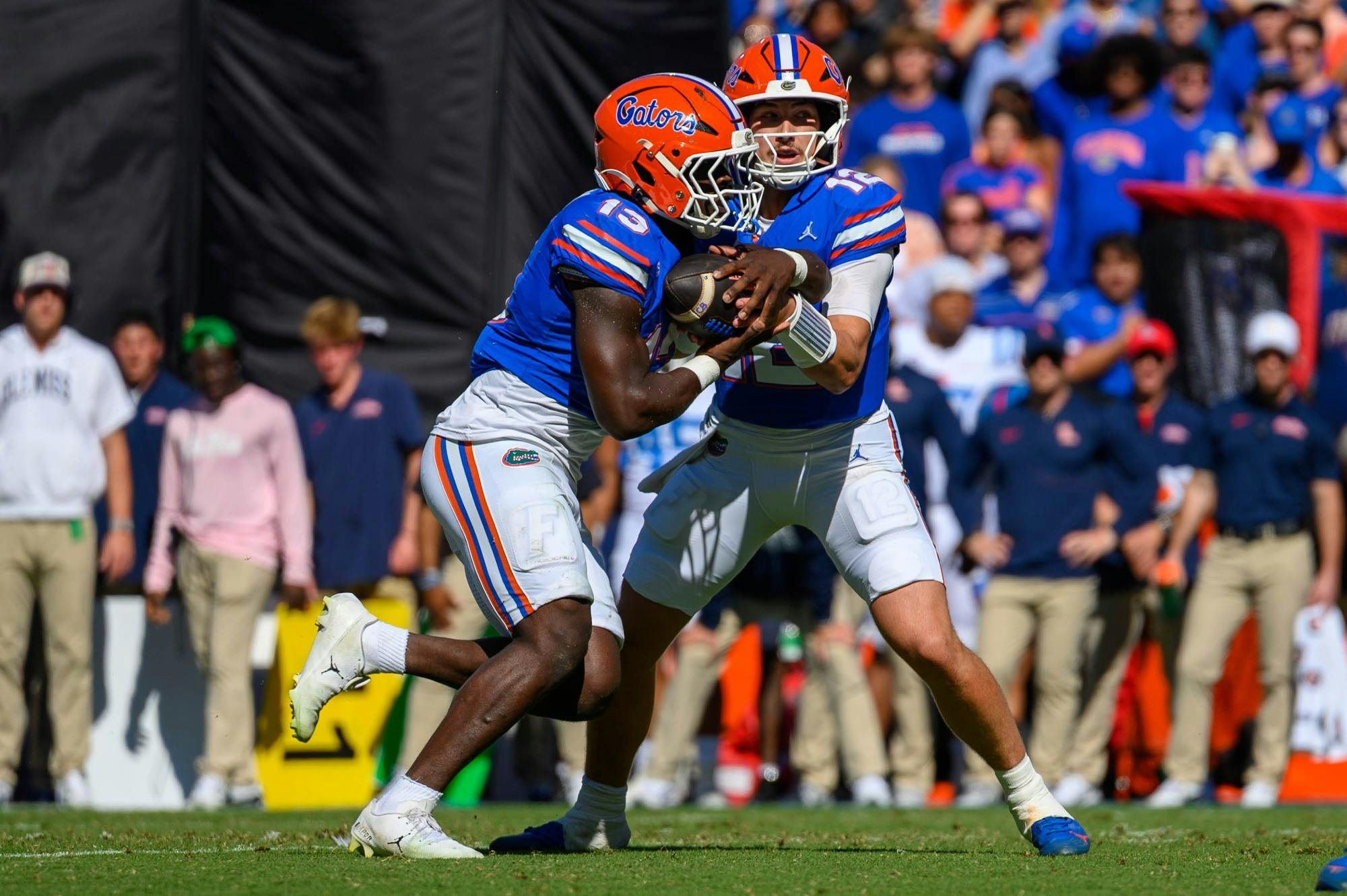 Florida quarterback Aaron Philo (12) passes to running back Jadan Baugh (13) during the first half of an NCAA college football game against Ole Miss, Saturday, Sept. 26, 2026, in Gainesville, Fla.