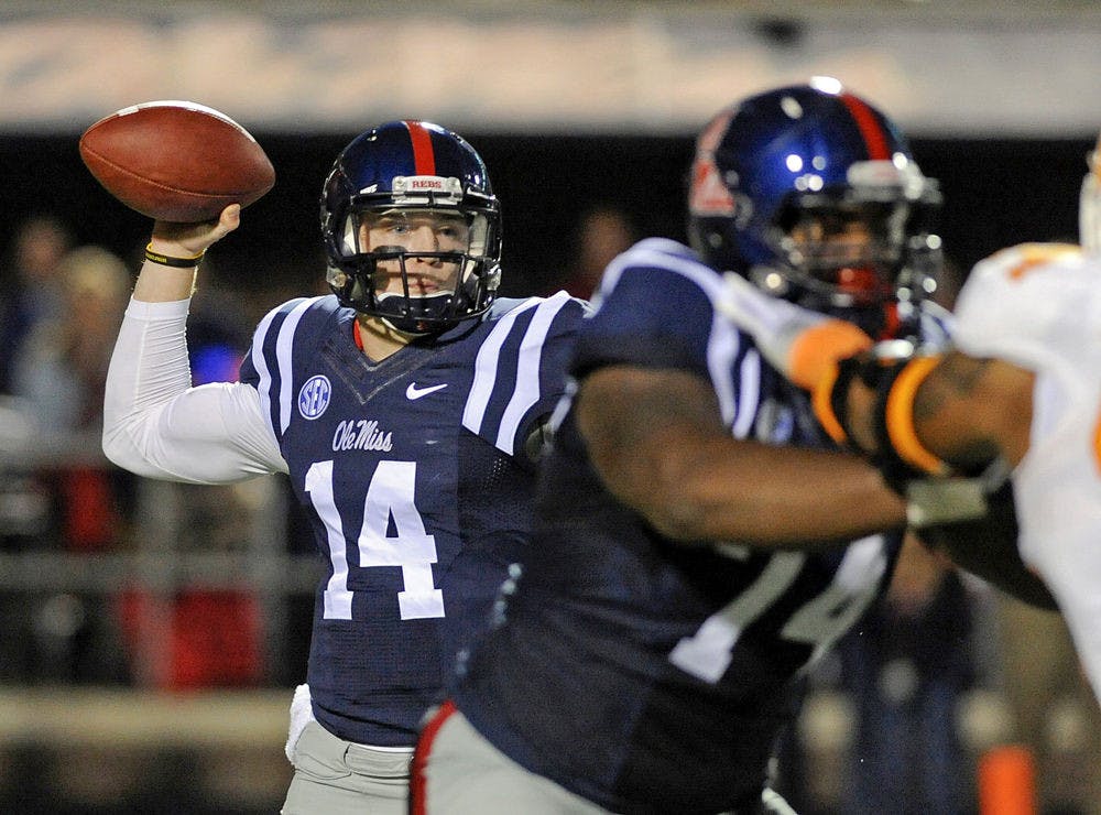 <p>Rebels quarterback Bo Wallace (14) releases a pass during the first half of Ole Miss' win against Tennessee in Oxford, Miss., on Saturday.</p>