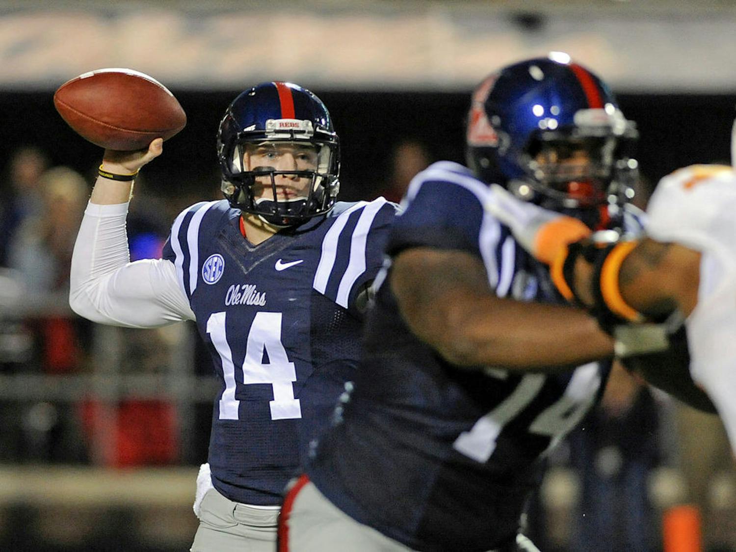 Rebels quarterback Bo Wallace (14) releases a pass during the first half of Ole Miss' win against Tennessee in Oxford, Miss., on Saturday.
