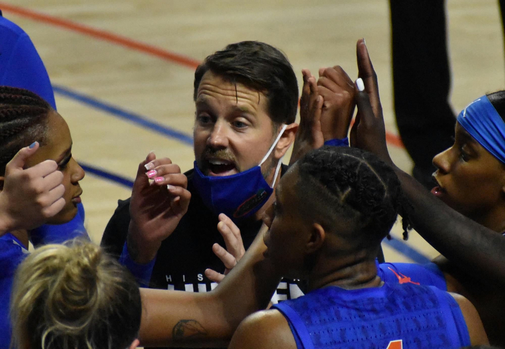 Former Florida coach Cam Newbauer in the huddle with his team in a game against Alabama on Feb. 18, 2021.