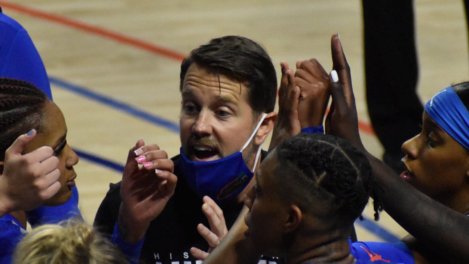Former Florida coach Cam Newbauer in the huddle with his team in a game against Alabama on Feb. 18, 2021.