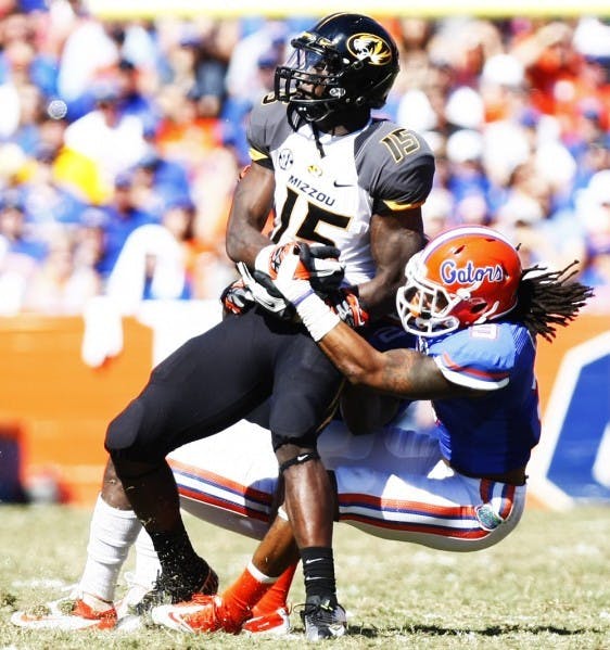 Safety Josh Evans (9) tackles wideout Dorial Green-Beckham (15) during Florida’s 14-7 win against Missouri on Nov. 3 in Ben Hill Griffin Stadium.&nbsp;
&nbsp;