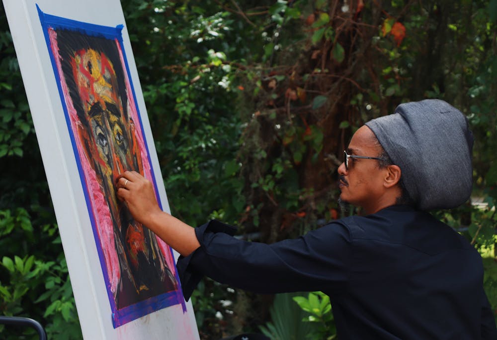 <p>Prince Merid Tafesse of Ethiopia, 47, draws a live sketch of Haile Selassie, a former Ethiopian emperor, with pastels at the A. Quinn Jones Museum &amp; Cultural Center on Saturday, Sept. 25, 2021. His exhibition is on display inside of the historic home-turned-museum.</p>