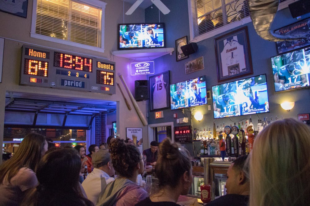 A packed crowd at The Swamp Restaurant watch the Super Bowl between the New England Patriots and Philadelphia Eagles on Sunday night. There were jerseys from both teams present.