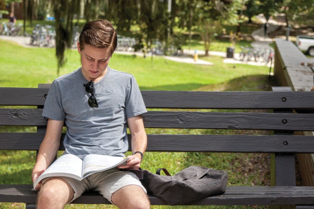 <p>Nathan Klemm, a mechanical engineering sophomore, reads a book before heading to class Oct. 7. A recent study suggests people who read often are considered more emotionally intelligent.</p>
