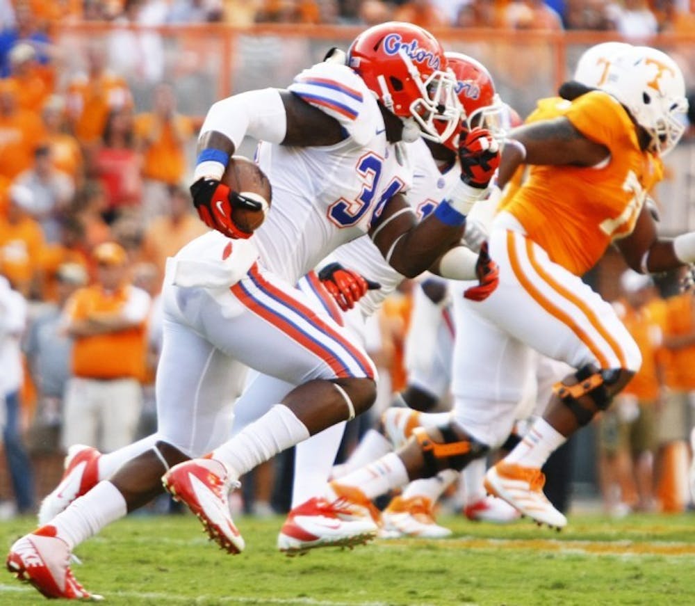 <p>Florida linebacker Lerentee McCray (34) sprints with the ball after intercepting a pass from Tennessee quarterback Tyler Bray (8) during a 37-20 victory over Tennessee on Saturday at Neyland Stadium.</p>