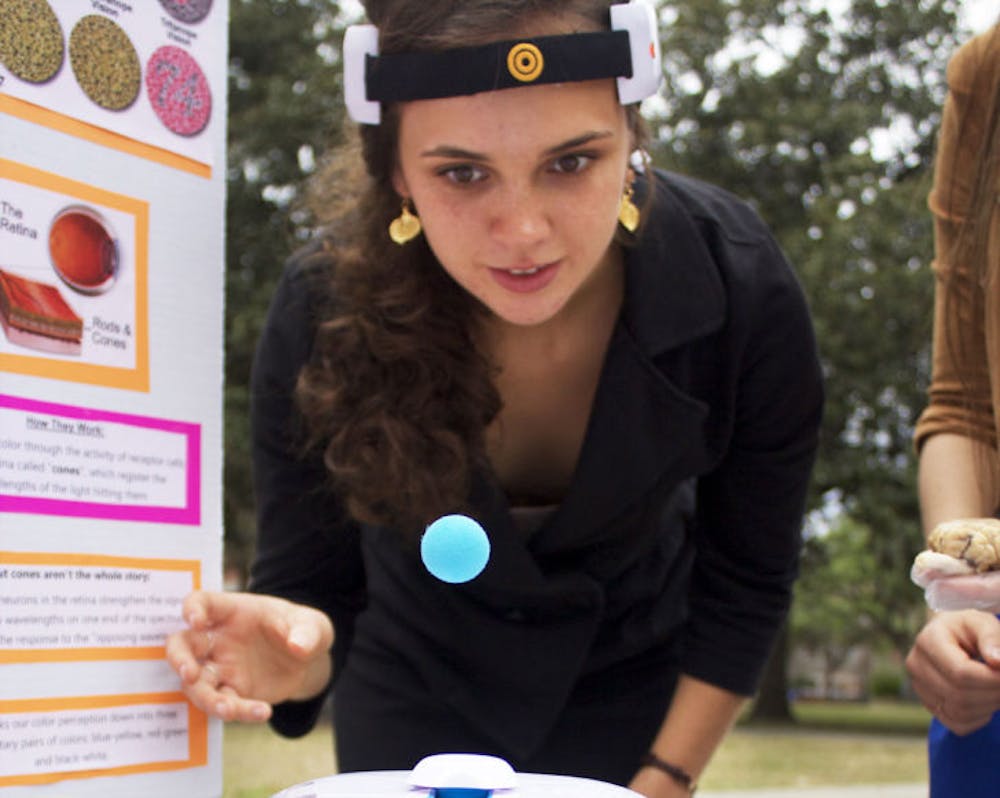 <p>Co-Chair of the Neuroscience Club Celeste Rousseau, a 19-year-old UF biological engineering sophomore, uses her mind to propel a ball for on-lookers Monday at the club’s booth on the Plaza of the Americas.</p>