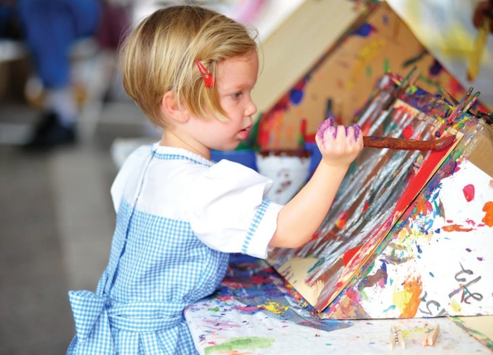 <p>Sissy Smith, 3, paints a picture at her first Downtown Festival and Art Show in Gainesville Sunday afternoon. The event had a children’s section called Imagination Station.</p>