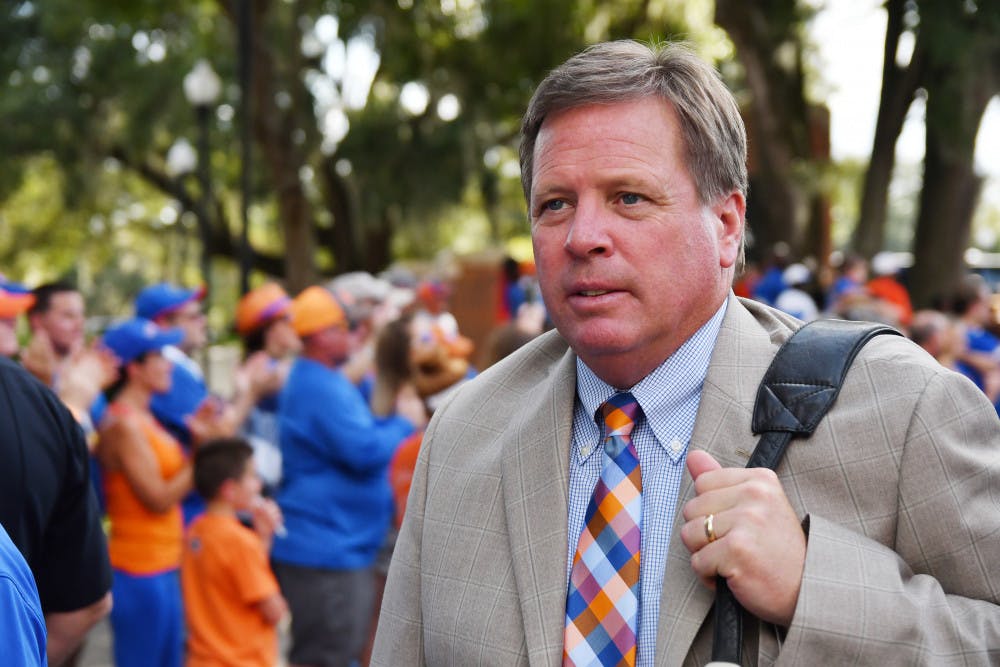 <p>Jim McElwain walks by fans before Florida's 32-0 win against North Texas on Sept. 17, 2016, at Ben Hill Griffin Stadium.</p>